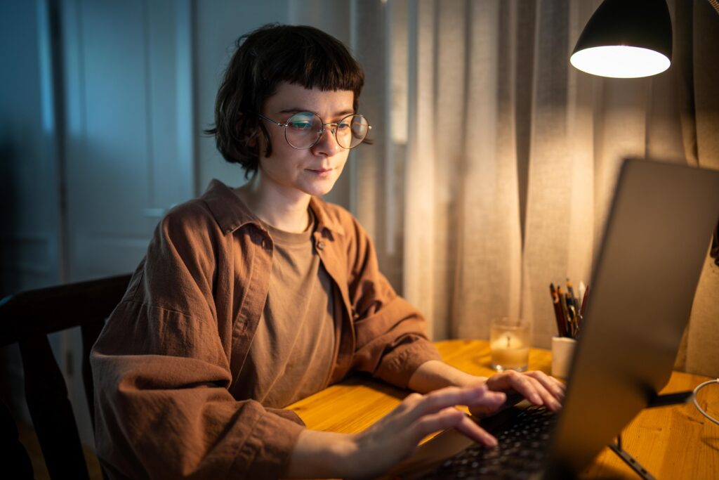 Exhausted indie author writing late at night after work